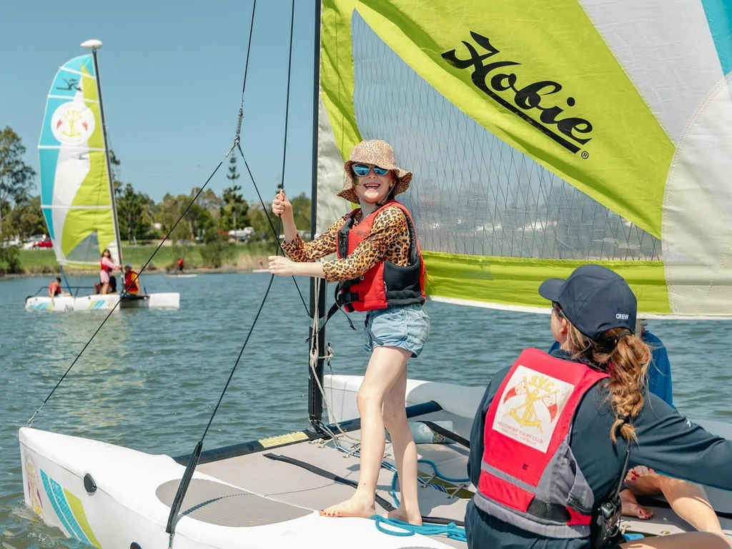 Smiling child on sail boat during school holidays