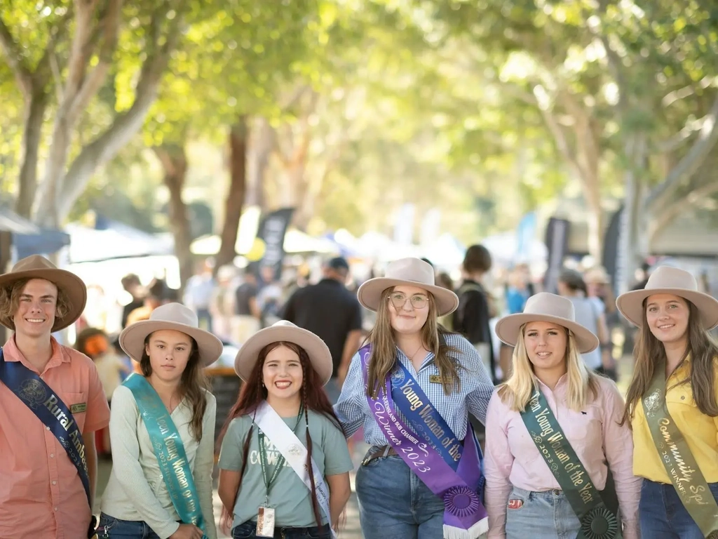A group of people with hats and sashes at the Show