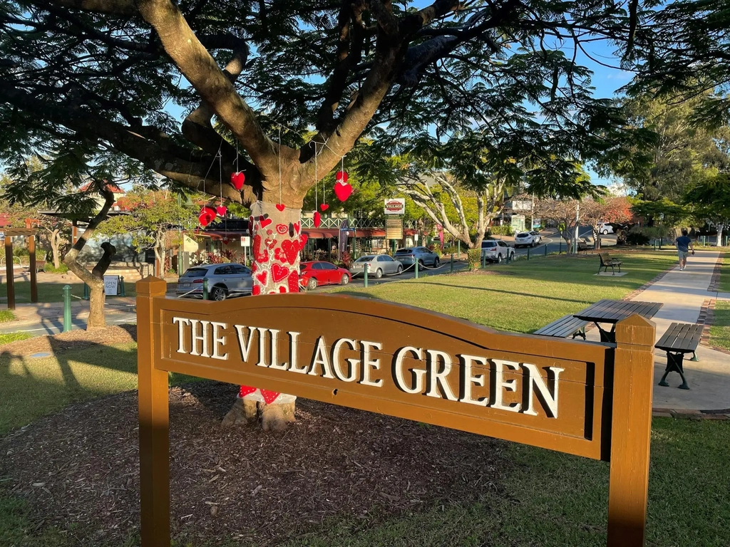 Green trees and brown sign
