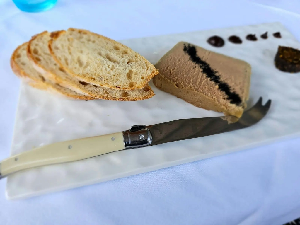 White plate featuring Pâté and locally sourced sourdough