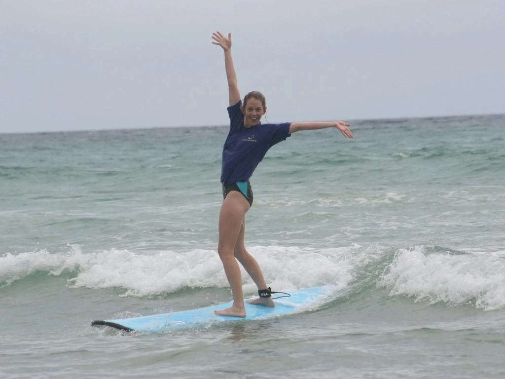 Pure stoke—a surf student celebrates riding a wave for the first time.